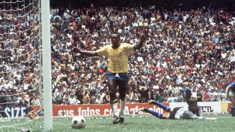 1970 World Cup Final, Mexico City, Mexico, 21st June, 1970, Brazil 4 v Italy 1, Pele raises his arms as he celebrates his captain Carlos Alberto's fourth goal with teammate Jairzinho (R) as Italian goalkeeper Enrico Albertosi lies beaten on the ground during the match  (Photo by Rolls Press/Popperfoto via Getty Images/Getty Images)